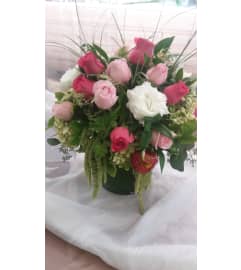 all shades of pink cylinder arrangement. An arrangement by Commerce Flowers.