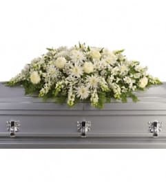 All white casket spray. An arrangement by Marianna's Flower Island.