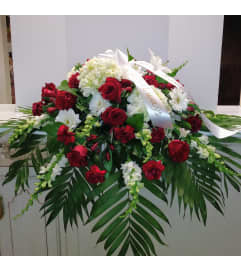 Remembered With Love Casket Spray. An arrangement by Violeta's Flower Shop.