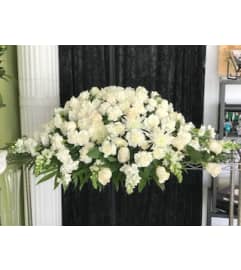 Pure White Casket Spray. An arrangement by Massey's House of Flowers.