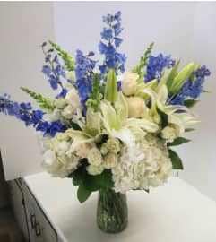 Blooms in White and Blue. An arrangement by Violeta's Flower Shop.