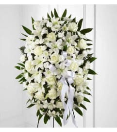 STANDING SPRAY WHITE. An arrangement by Elegant Florist.