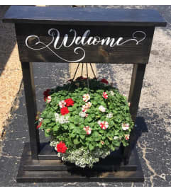 HANGING BASKET WELCOME SIGN. An arrangement by Beehive Florist.