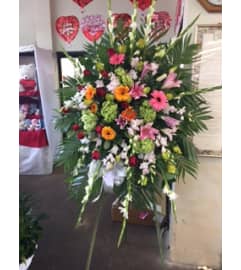 green pink yellow and red spray. An arrangement by Commerce Flowers.
