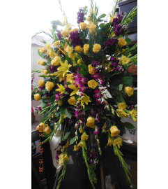 yellow and purple standing spray. An arrangement by Commerce Flowers.