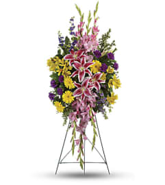 The Rainbow of Remembrance Spray. An arrangement by Flowers of Jacksonville.