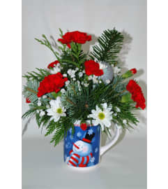 Flowering Christmas Mug. An arrangement by Flowers Plus. Flowering Christmas Mug. An arrangement by Flowers Plus.