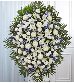 The Blue and White Sympathy Standing Spray. An arrangement by Flowers of Jacksonville.