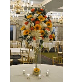 DELUXE CENTERPIECE ON GLASS VASE. An arrangement by Flowers by Priscilla.