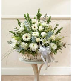 Three-Sided Arrangement of Assorted white Flowers in Low basket. An arrangement by Flowers by Priscilla.