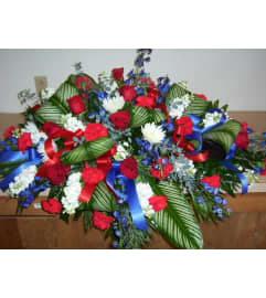 Patriotic Goodbyes Spray. An arrangement by Doyle's Flower Shop.
