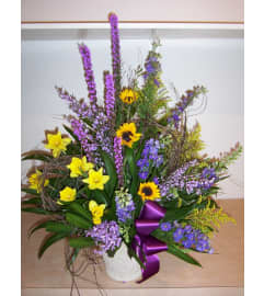 Spring Funeral Basket. An arrangement by Doyle's Flower Shop.