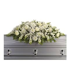 The Enduring Light Casket Spray. An arrangement by Flowers of Jacksonville.