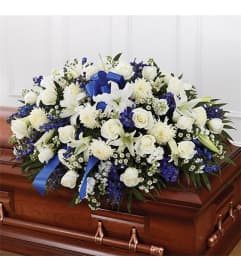 Sympathy Blue and White Half Casket Cover. An arrangement by Burlington Flowers.