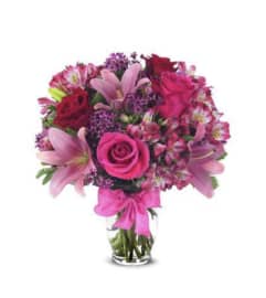 Its Roses and Lilies. An arrangement by Seasons Change Designs.