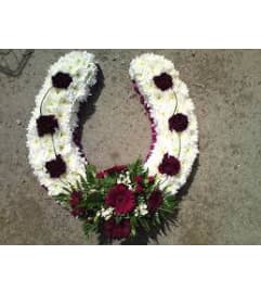 wreathe unique. An arrangement by Flowers 4 U Helping Hand.