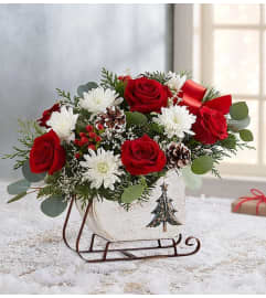 Dashing Through the Snow Sleigh™. An arrangement by Butterflies Flower Shop.
