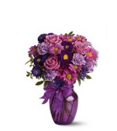 ASSORTED PURPLE FLOWERS ARRANGED LOOSE and AIRY IN A VASE. An arrangement by Flowers by Priscilla.