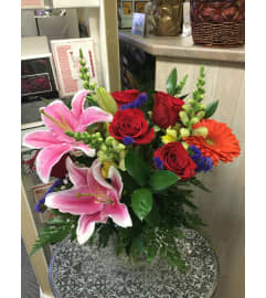 Brighten lovely flowers in vase by Vivian. An arrangement by Vivian Flowers.