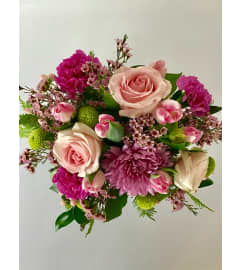 Lush hand-tied bouquet. An arrangement by Prestige Floral.