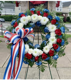 Patriotic Sympathy Wreath. An arrangement by Violeta's Flower Shop.