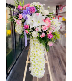 Cross Soft Lavender. An arrangement by Geni's Florist and Gifts.