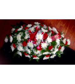 Traditional casket spray. An arrangement by Flowers in Bloom.