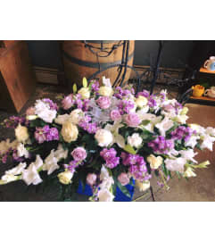 Exquisite Lavender Casket spray. An arrangement by Flowers in Bloom.