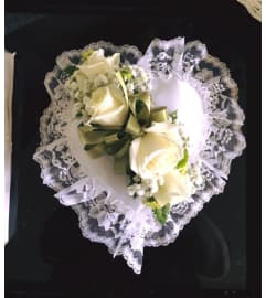 Heartshaped casket pillow. An arrangement by Flowers in Bloom.