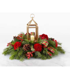 HOMESICK WREATH. An arrangement by Geni's Florist and Gifts.