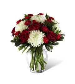 The Holiday Enchantment Bouquet FTD. An arrangement by Pine Knoll Florist.