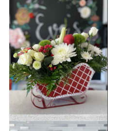 christmas sleigh flowers. An arrangement by Florist of the Northwoods. christmas sleigh flowers. An arrangement by Florist of the Northwoods.