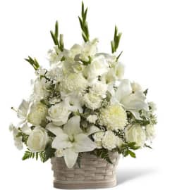 WHITE WIKER BASKET. An arrangement by Elegant Florist.