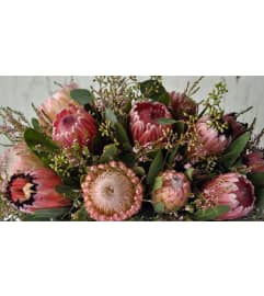 LOW HOLIDAY ARRANGEMENT - ELEGANT. An arrangement by Flowers by Priscilla.