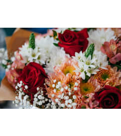 Designer's Choice Wrapped Hand Bouquet. An arrangement by Royal Louis Florist. Designer's Choice Wrapped Hand Bouquet. An arrangement by Royal Louis Florist.