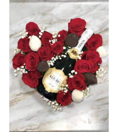 Rose Box With Berries And Champagne. An arrangement by Margaret's Florist.