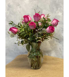 Pink by the Dozen. An arrangement by Masters and Company Florist.