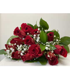 A beautiful dozen red roses wrapped. An arrangement by Flower Trends Florists.