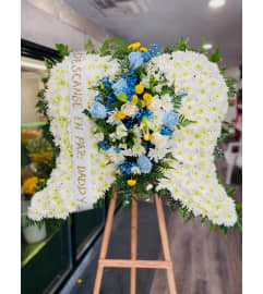 BABY BLUE WINGS. An arrangement by Geni's Florist and Gifts.