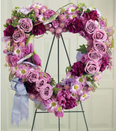 Heartfelt Sympathies Heart. An arrangement by Elegant Florist.