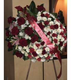 PUFFY WREATH. An arrangement by Geni's Florist and Gifts.