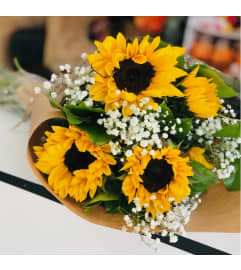 SUNFLOWERS WRAP. An arrangement by Geni's Florist and Gifts.