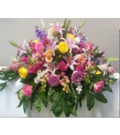 SPRING CASKET. An arrangement by Geni's Florist and Gifts.