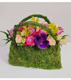 MaMa's HANDBAG. An arrangement by Twigs Flower Company. MaMa's HANDBAG. An arrangement by Twigs Flower Company.