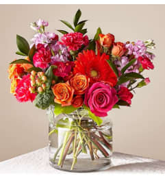 BRIGHT FIESTA BOUQUET. An arrangement by Geni's Florist and Gifts.