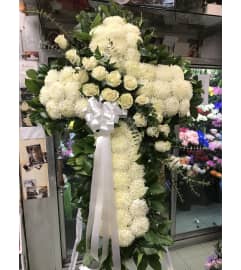 Elegant Standing Cross White. An arrangement by Elegant Florist.