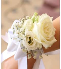 CORSAGE GUZMAN. An arrangement by Geni's Florist and Gifts.