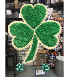 Standing Spray Shamrock Green and White. An arrangement by Elegant Florist.