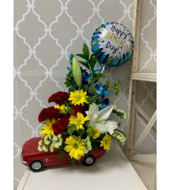 Red Mustang arrangement. An arrangement by Shalimar Flower Shop.