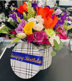 PLAID AND BRIGHT. An arrangement by Geni's Florist and Gifts.